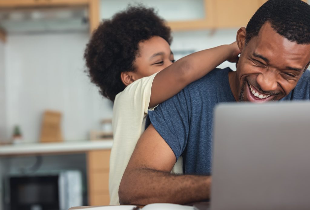 A parent and child booking a gymnastics class on a laptop